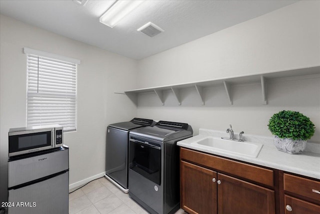 washroom with washing machine and clothes dryer and sink