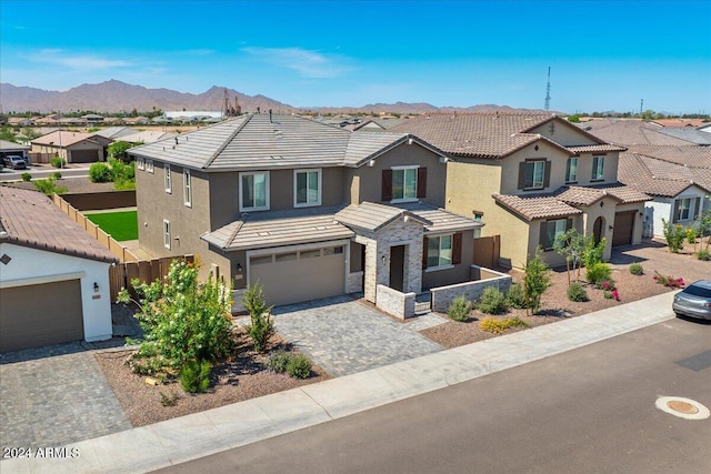 view of front of home with a mountain view and a garage