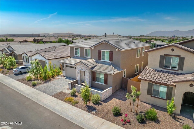 view of front of property featuring a mountain view and a garage