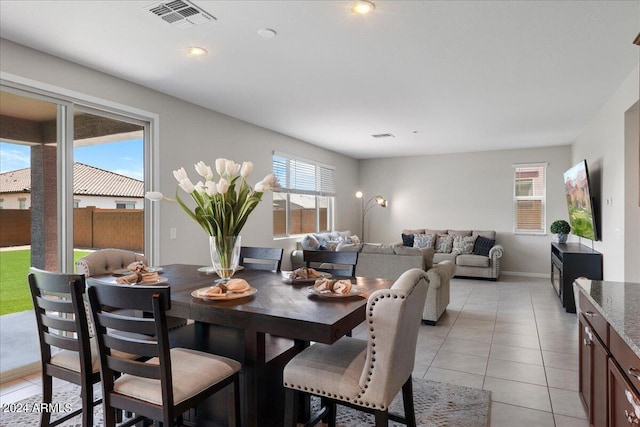 dining area featuring light tile patterned flooring