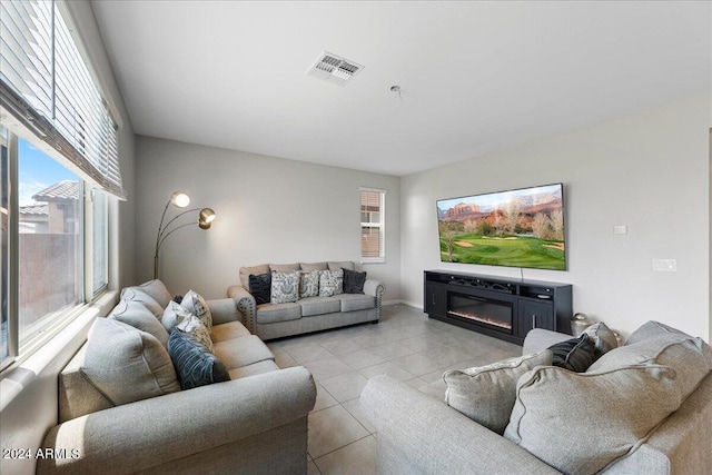 living room with light tile patterned floors and plenty of natural light