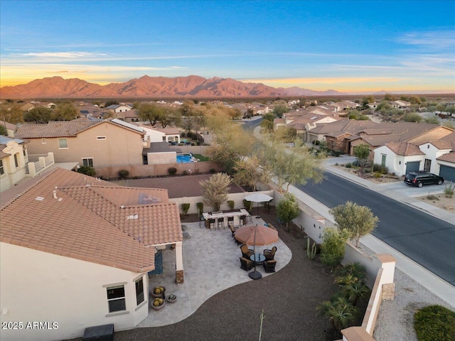 aerial view at dusk with a residential view and a mountain view