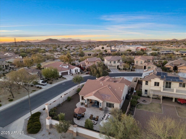 aerial view at dusk with a mountain view and a residential view