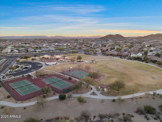 aerial view at dusk featuring a mountain view and a residential view