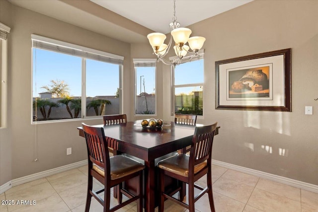 dining room with light tile patterned floors, an inviting chandelier, and baseboards