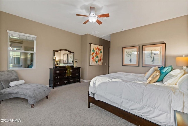 bedroom featuring ceiling fan, visible vents, baseboards, and light colored carpet