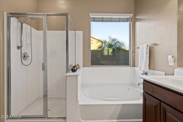 bathroom with a stall shower, vanity, and a bath