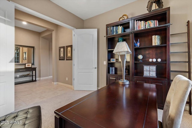 office space with light tile patterned flooring, light colored carpet, and baseboards