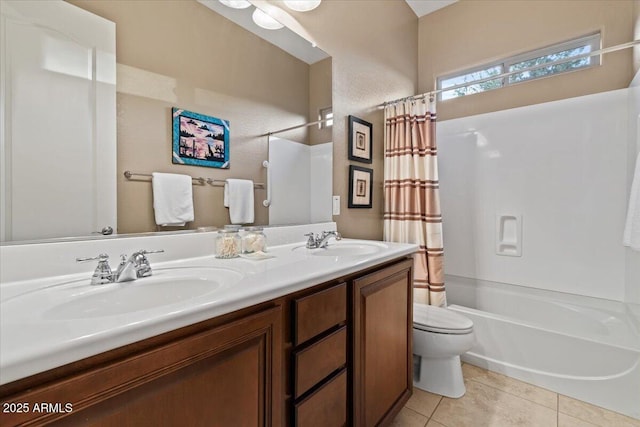 bathroom featuring tile patterned flooring, a sink, toilet, and shower / bath combo