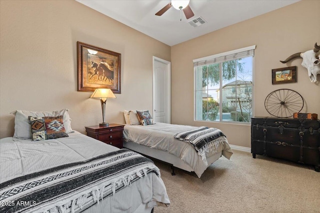 bedroom featuring light carpet, baseboards, visible vents, and a ceiling fan