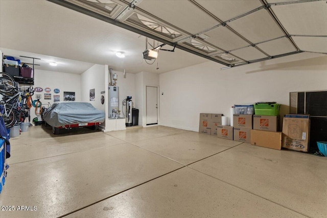 garage featuring a garage door opener and water heater