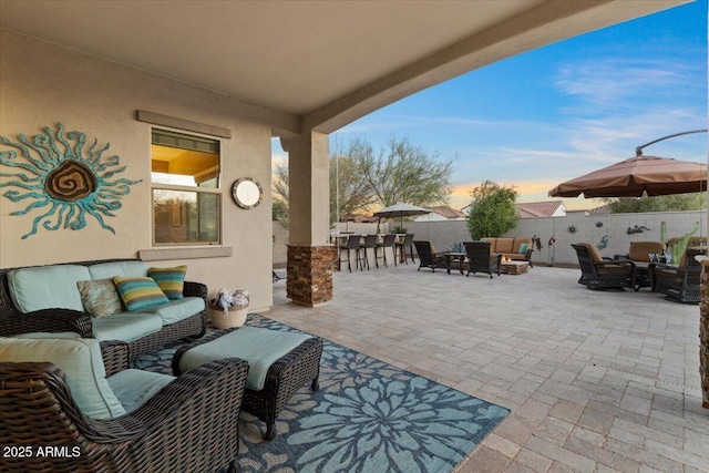 view of patio / terrace featuring an outdoor hangout area, outdoor dry bar, and fence