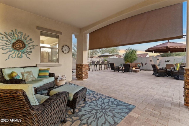 view of patio / terrace featuring an outdoor hangout area and fence