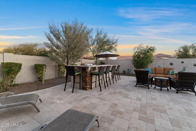 view of patio / terrace featuring a fenced backyard, outdoor dry bar, and an outdoor hangout area