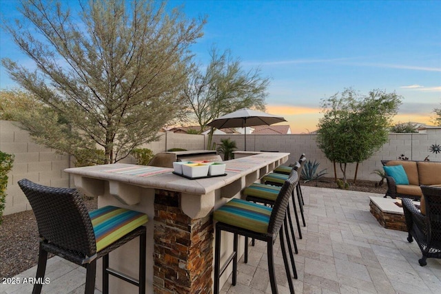 view of patio / terrace with a fenced backyard and outdoor dry bar