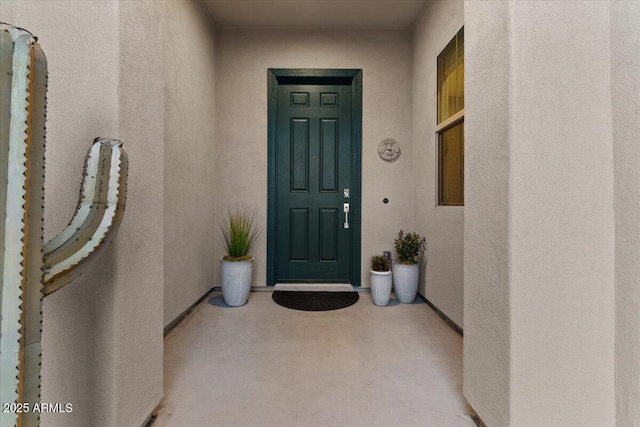 view of exterior entry with stucco siding