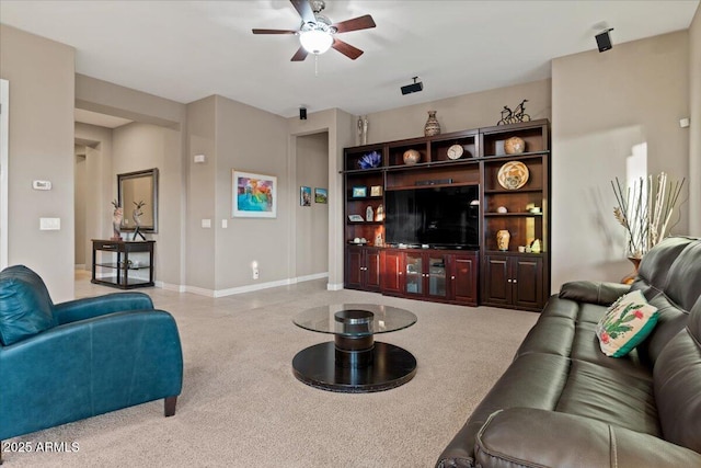 living room featuring ceiling fan and baseboards