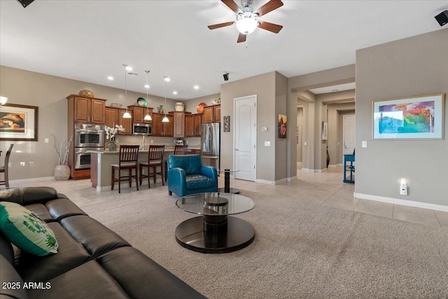 living area featuring light tile patterned floors, recessed lighting, a ceiling fan, and baseboards