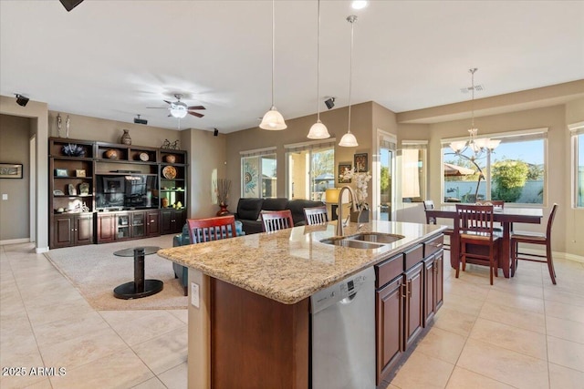 kitchen with a sink, visible vents, hanging light fixtures, stainless steel dishwasher, and a center island with sink