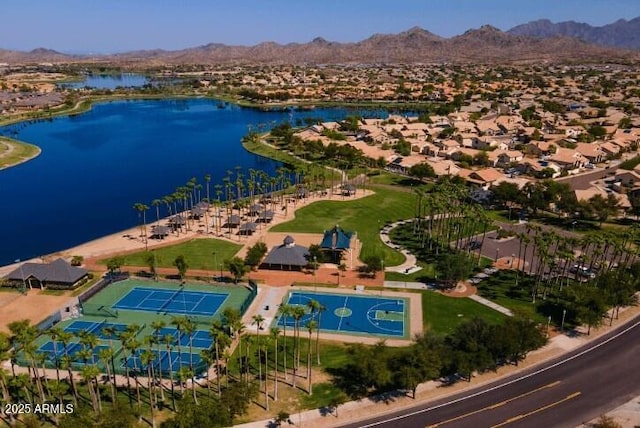 drone / aerial view with a water and mountain view