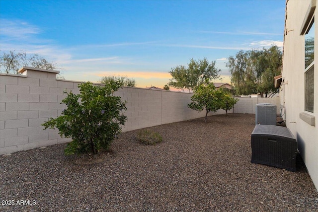 view of yard with cooling unit and a fenced backyard