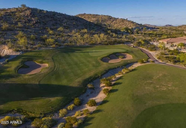 birds eye view of property with a mountain view and golf course view