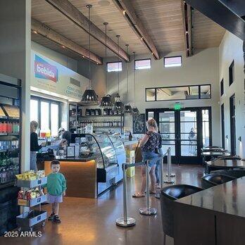 workout area with wood ceiling, french doors, and a towering ceiling