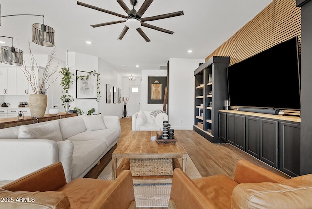 living room featuring ceiling fan, light wood-style flooring, and recessed lighting