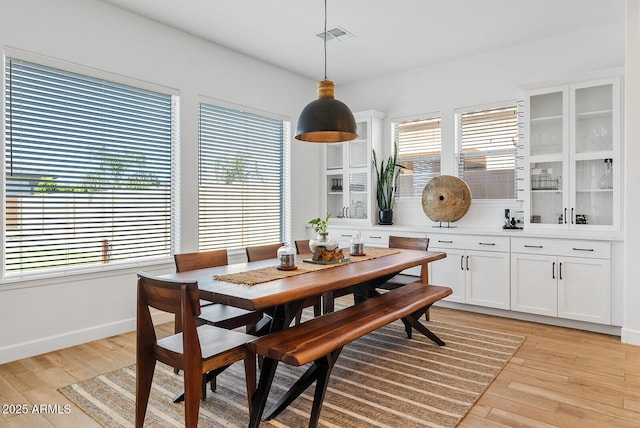 dining area featuring light wood-type flooring and baseboards