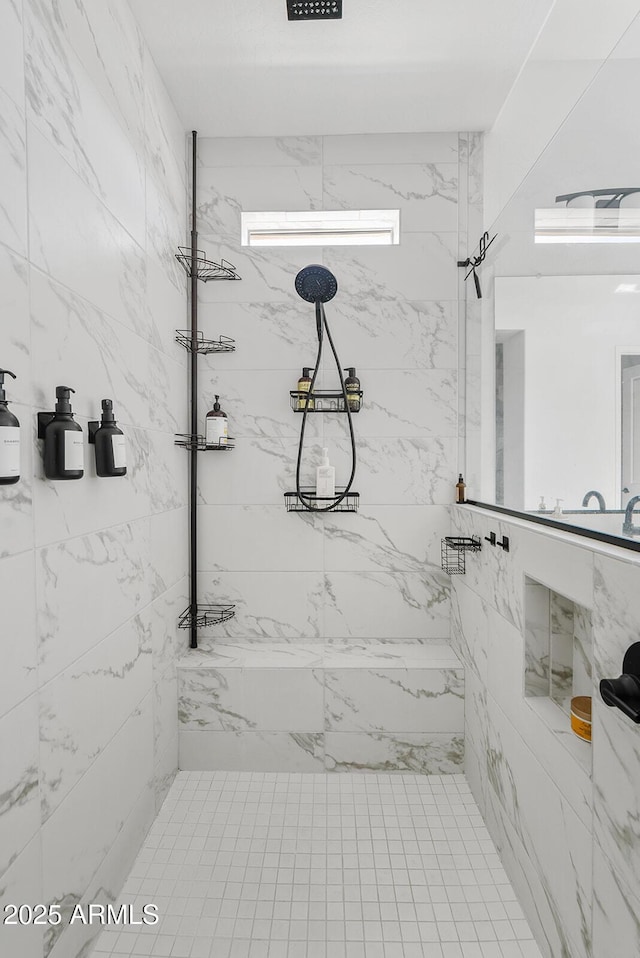 full bath with a marble finish shower