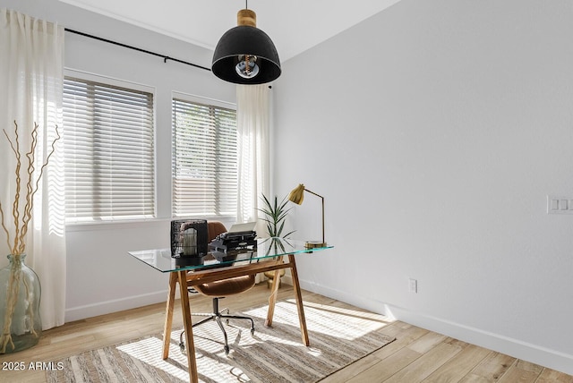 office space with light wood-type flooring and baseboards