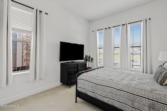 carpeted bedroom with baseboards