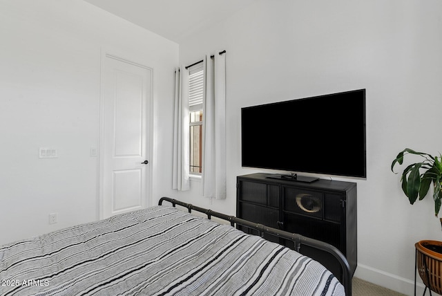 bedroom with baseboards and carpet