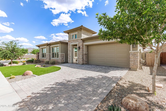 prairie-style home featuring stone siding, stucco siding, a garage, and decorative driveway