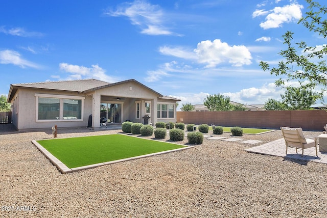 back of property featuring a patio, stucco siding, and a fenced backyard