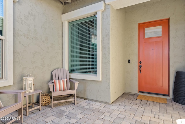 view of exterior entry with stucco siding