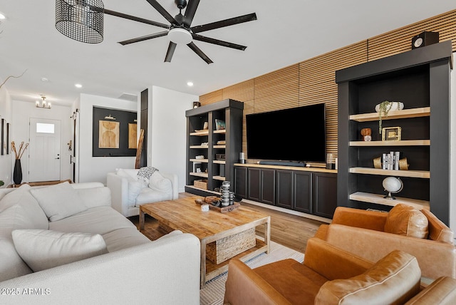 living area featuring light wood-type flooring, ceiling fan, and recessed lighting