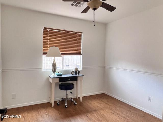 home office with hardwood / wood-style flooring and ceiling fan