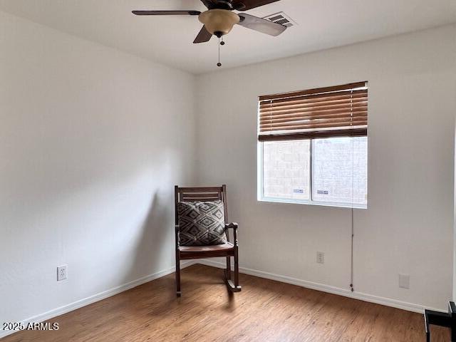 sitting room featuring ceiling fan and light hardwood / wood-style floors