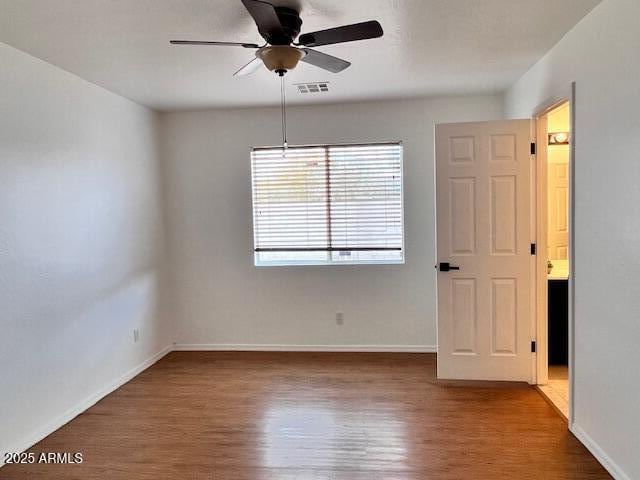 spare room with ceiling fan and hardwood / wood-style floors