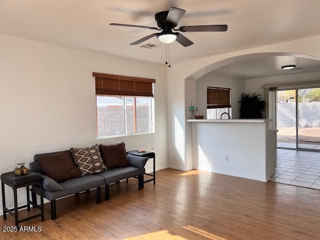 living room with hardwood / wood-style floors and ceiling fan