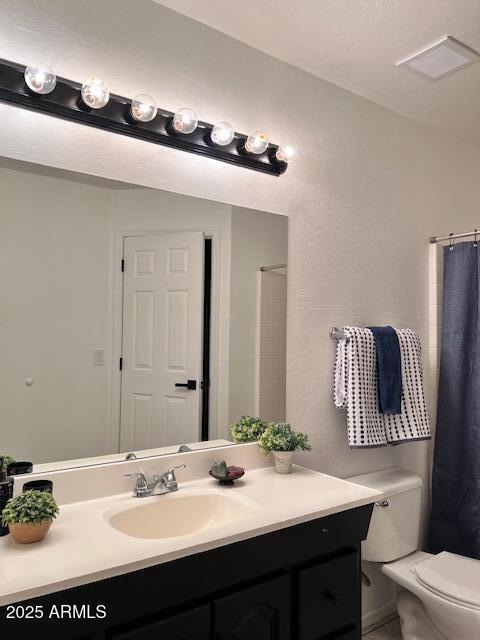 bathroom featuring vanity, a shower with curtain, and toilet