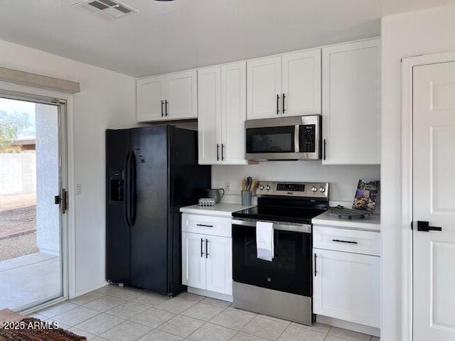 kitchen featuring white cabinetry, appliances with stainless steel finishes, and light tile patterned floors