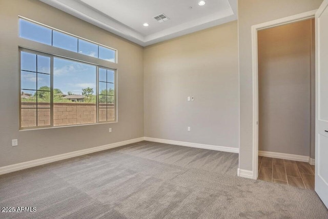 unfurnished room featuring carpet flooring, recessed lighting, baseboards, and visible vents