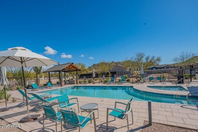 pool with a gazebo, a patio, fence, and a hot tub