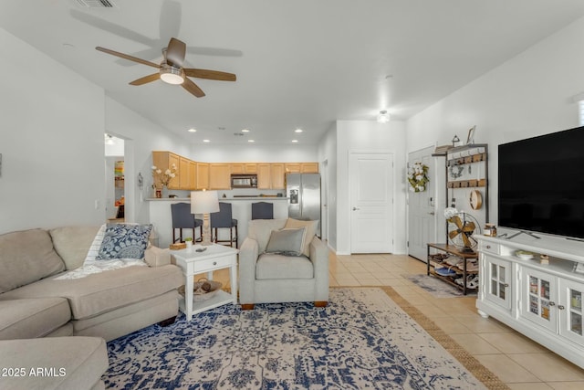 living area with recessed lighting, a ceiling fan, and light tile patterned flooring