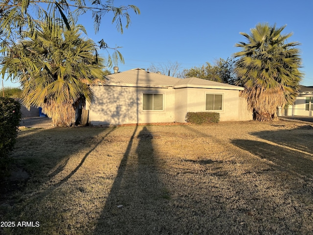 back of house with a lawn