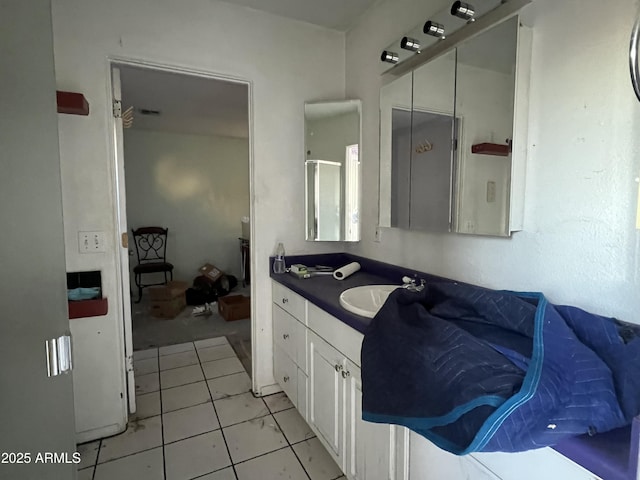 bathroom with tile patterned flooring, a shower with door, and vanity