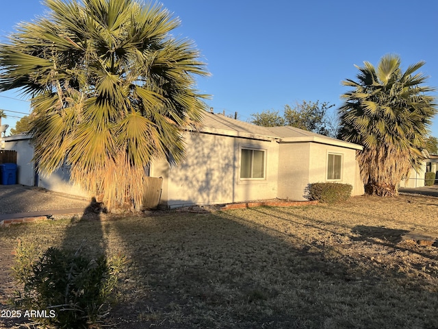 view of side of home with a lawn