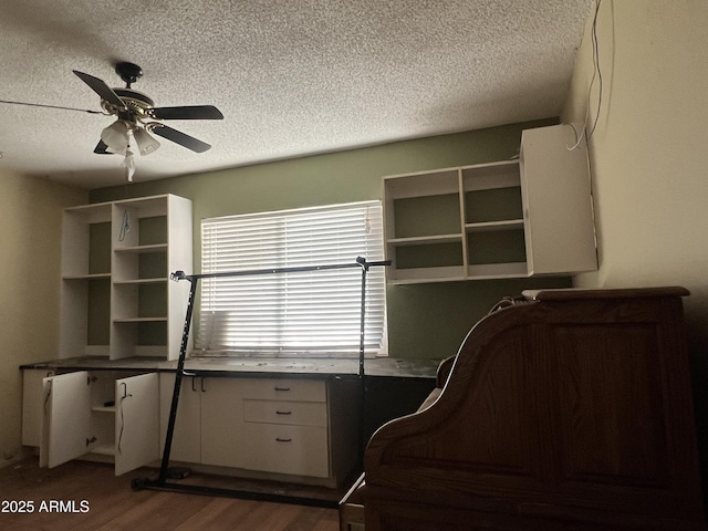 unfurnished bedroom featuring a textured ceiling, ceiling fan, and dark hardwood / wood-style flooring